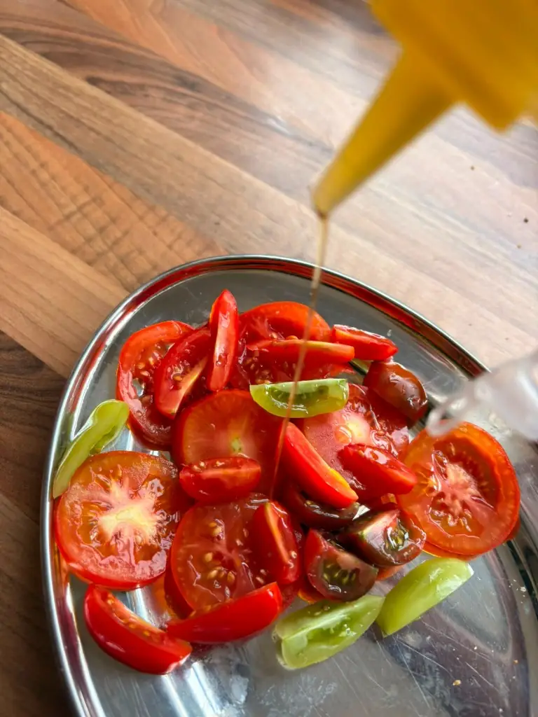 Olive oil over tomatoes